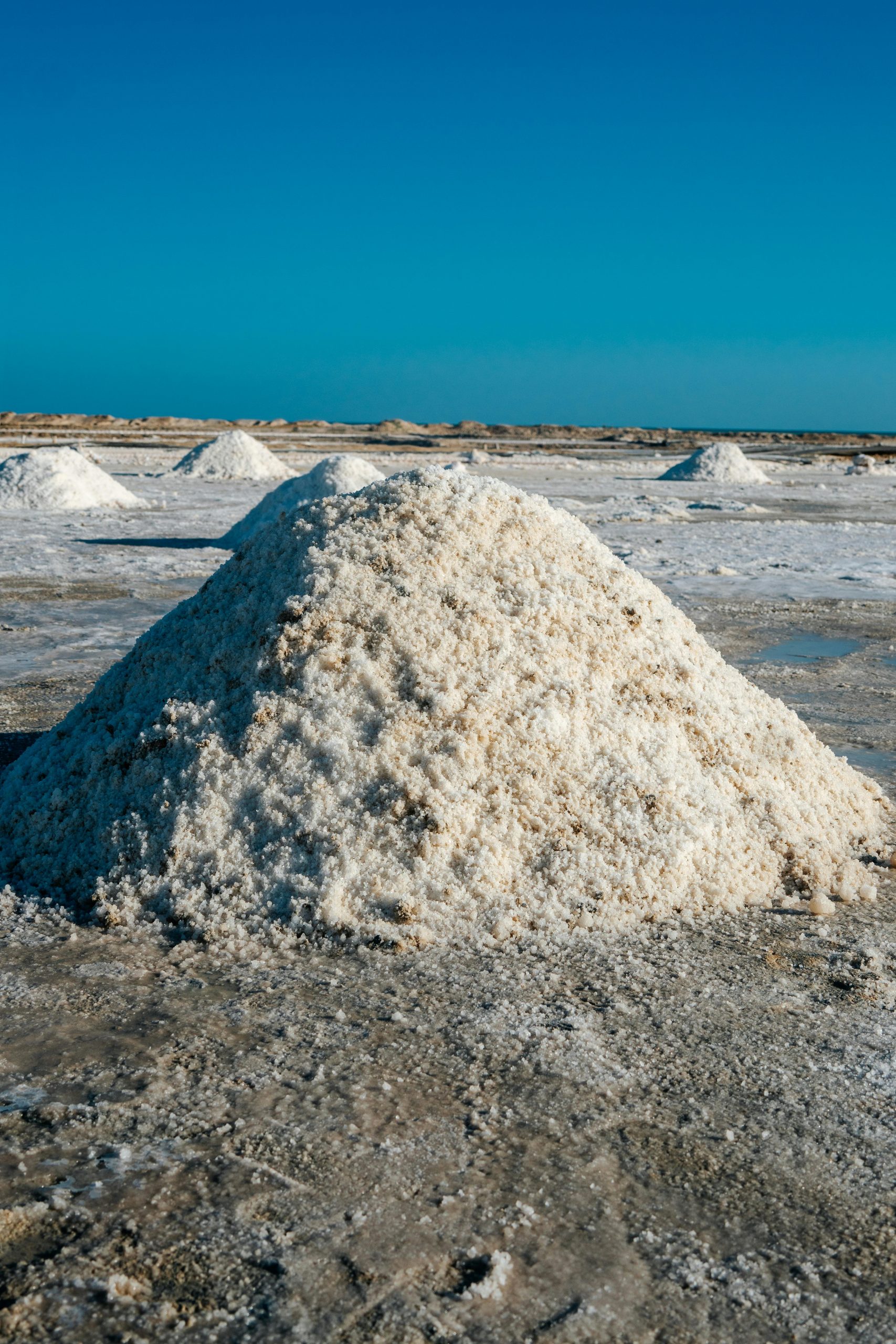 Scenic salt dunes in La Guajira, Colombia under a clear blue sky.